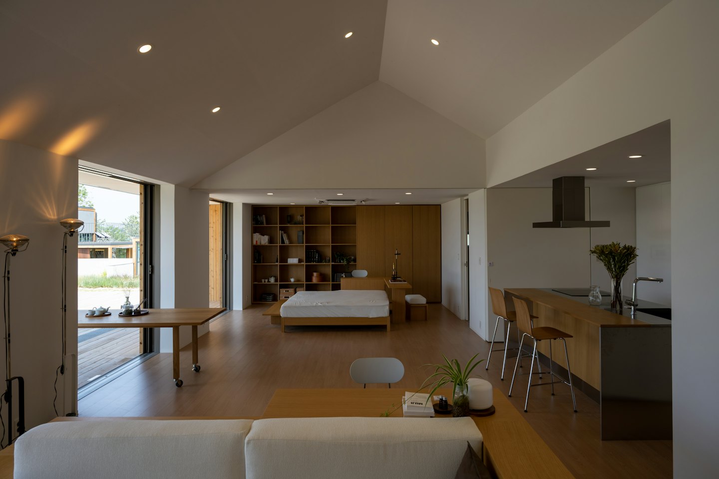 Modern open plan apartment with living room and kitchen area.